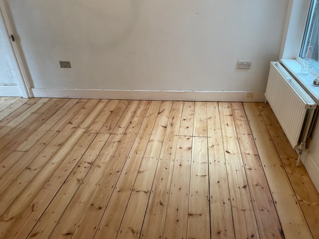 Wood floor repair and gap filling in a small apartment, West Ham